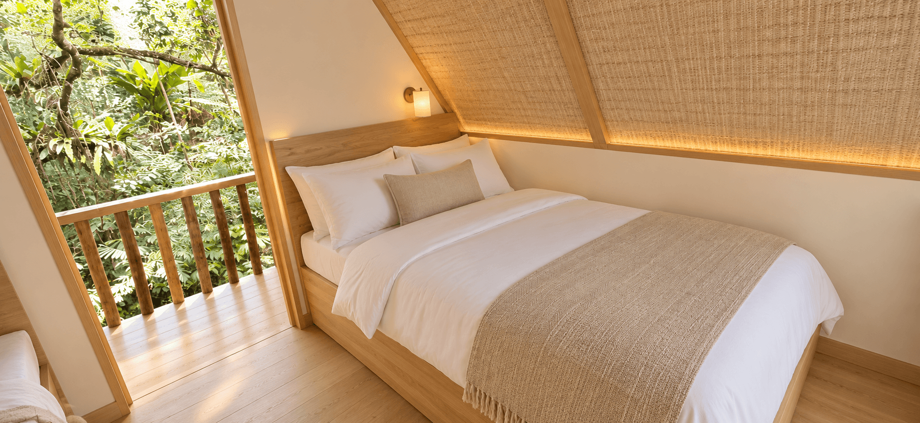 Couple's Cabin interior with a full-sized bed beside an open balcony